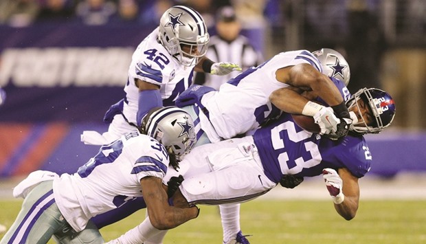 New York Giants running back Rashad Jennings (No 23) is tackled by Dallas Cowboys corner back Brandon Carr (No 39) and Dallas Cowboys linebacker Anthony Hitchens (No 59) during the second quarter at MetLife Stadium. PICTURE: USA TODAY Sports