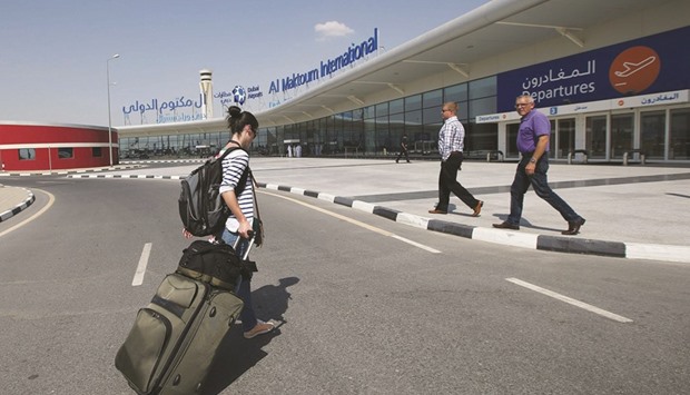 A passenger walks on her way into the Dubai World Centralu2013Al Maktoum International Airport, in Jebel Ali, Dubai (file). The emirate is developing Al Maktoum close to the Expo 2020 site with an annual capacity of about 220mn passengers and plans to move flagship carrier Emirates by 2025.