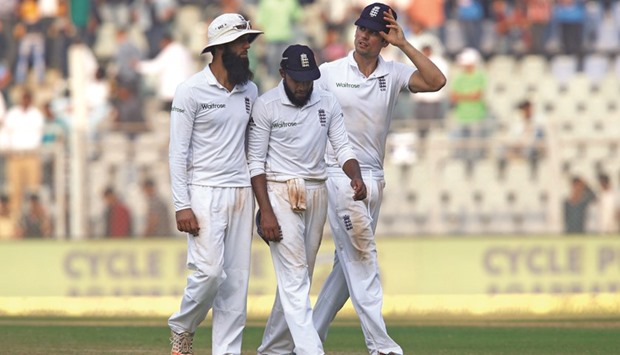 Englandu2019s Moeen Ali (left), Adil Rashid (centre) and Alastair Cook walk off the field at Wankhede Stadium. Referring to the 2012 Test in Mumbai. (Reuters)