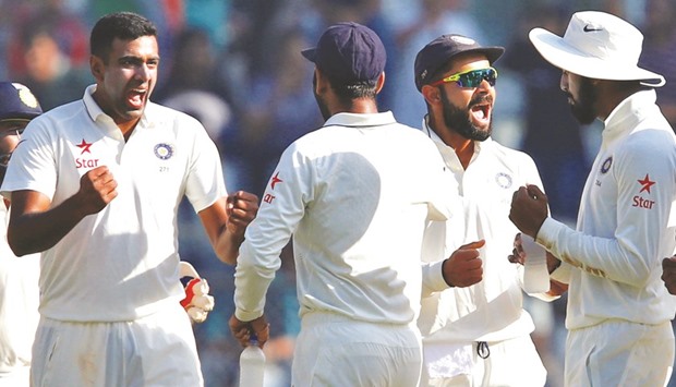 Indiau2019s R Ashwin (left) and Virat Kohli (second from right) celebrate a wicket on Day Five of the fourth Test against England in Mumbai yesterday. (Reuters)