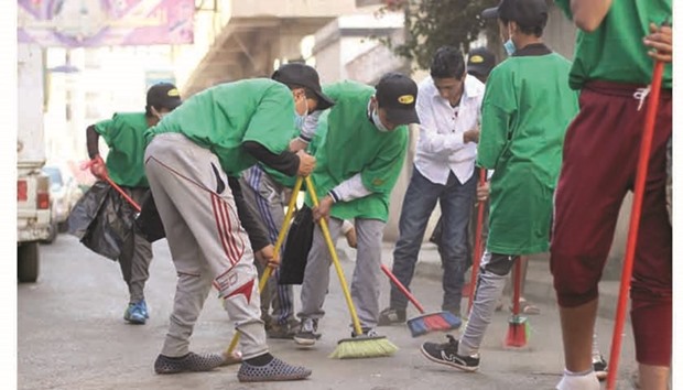 Yemeni youth sweep a street as they take part in a cleaning campaign in the capital Sanaa yesterday. Unicef yesterday said Yemenu2019s health system was on the verge of collapse.