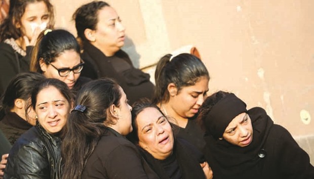 Egyptian Christians react during the funeral of victims killed in the bombing of Cairou2019s Coptic cathedral, at the Mokattam Cemetery in Cairo, yesterday.
