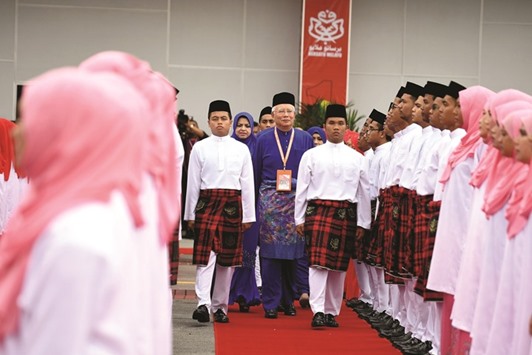 Malaysian Prime Minister Najib Razak inspects a ceremonial guard of honour during the annual congress of his ruling party, the United Malays National Organisation yesterday.