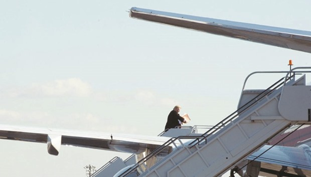 Trump walks up to board his plane at LaGuardia Airport, New York, yesterday. He was headed to Indianapolis, Indiana, to speak to workers at the Carrier factory.