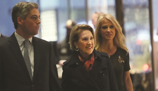 American businesswoman Carly Fiorina (centre) walks into Trump Tower yesterday with political strategist Kellyanne Conway in New York City. President-elect Donald Trump continues to hold meetings with potential members of his cabinet at his office.