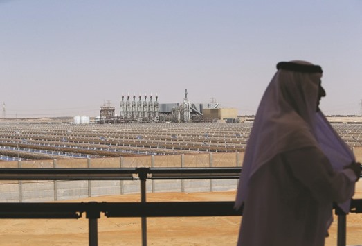 An Emarati stands on a balcony overlooking the Shams 1,  Concentrated Solar power (CSP) plant, in Al-Gharibiyah district on the outskirts of Abu Dhabi. Green projects could benefit from tapping Islamic banks in countries like the UAE and Malaysia, where they now hold a quarter of total banking assets.