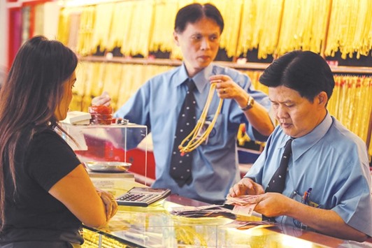 A customer buys gold at a jewellery shop in Bangkok. Gold joins equities, real estate, Islamic bonds (sukuk) and takaful as vehicles approved for Islamic finance, according to the Bahrain-based AAOIFI.