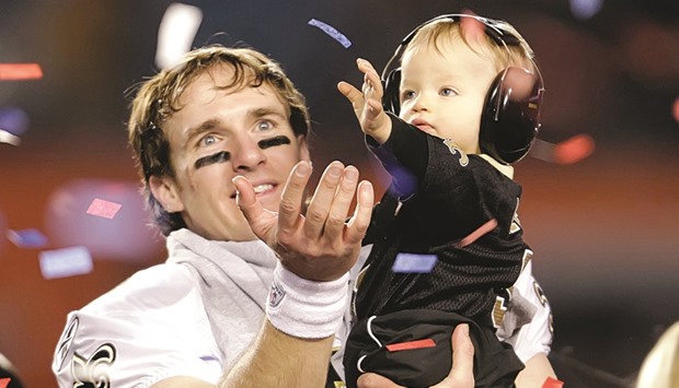 A toddler wearing protective earmuffs.