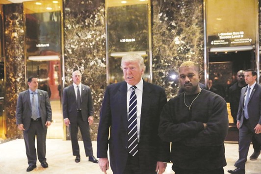 US president-elect Donald Trump and musician Kanye West pose for media at Trump Tower in Manhattan, New York City, yesterday.