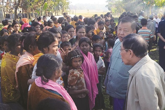 This handout photograph released yesterday by the Myanmar State Counsellor Office shows Rakhine State Investigation Commission officials meeting residents of Gwazon, a Muslim majority village in Maungdaw located in Rakhine State near the Bangladesh border.