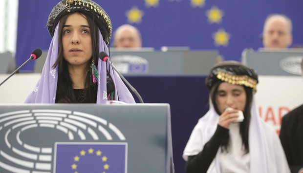Nadia Murad Basee addresses the European Parliament during the award ceremony for their 2016 Sakharov Prize at the European Parliament in Strasbourg. Behind her is Lamya Haji Bashar.
