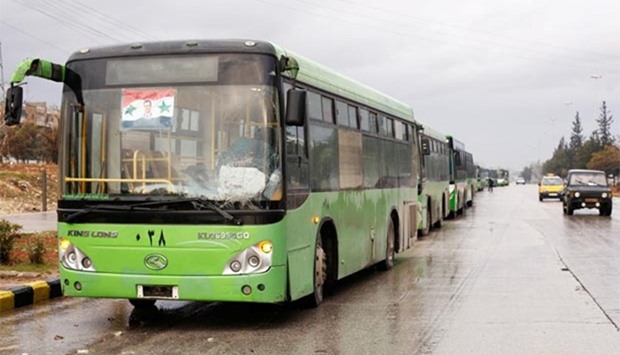 Buses wait to evacuate people from a rebel pocket in Aleppo on Wednesday.