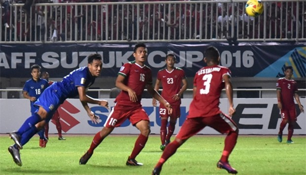 Thailand's Theerasil Dangda (L) scores a goal during the AFF Suzuki Cup final football match between Indonesia and Thailand