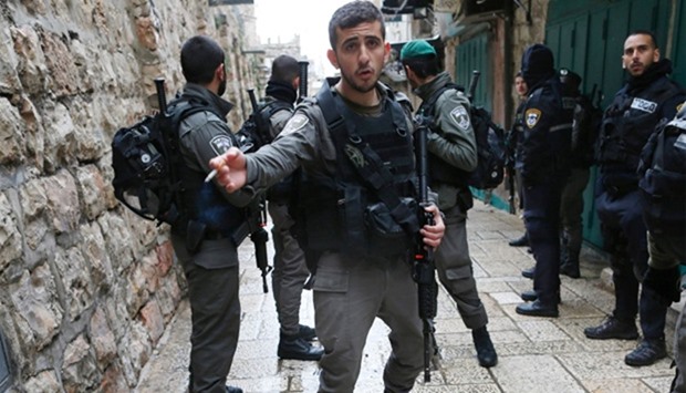 Israeli security forces patrol the streets near the site where a Palestinian was shot by Israeli police