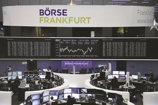 Traders work at the Frankfurt Stock Exchange. The DAX 30 closed down 0.4% to 11,244.84 points yesterday.