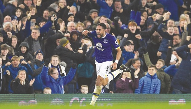 Evertonu2019s English-born Welsh defender Ashley Williams celebrates scoring his teamu2019s second goal during the English Premier League match between Everton and Arsenal.