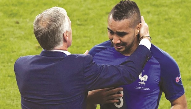 This file photo shows Franceu2019s forward Dimitri Payet (R) being congratulated by Franceu2019s coach Didier Deschamps.