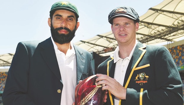 Pakistan captain Misbah-ul-Haq and his Australian counterpart Steven Smith hold the Test series trophy at the Gabba in Brisbane yesterday, ahead of todayu2019s pink ball day-night Test. (AFP)