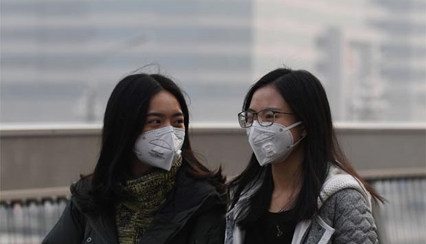 Two women wear masks on a polluted day in Beijing this week.