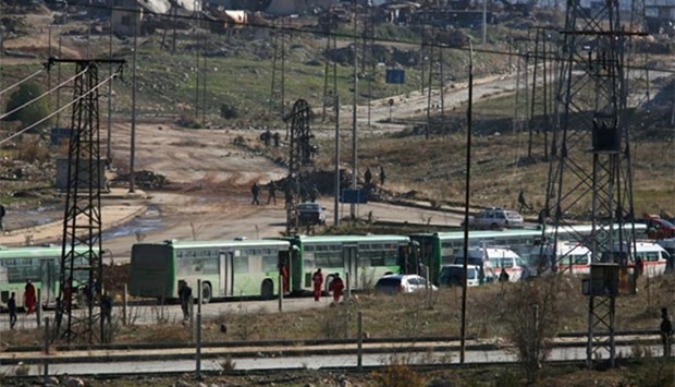 Buses and ambulances wait to evacuate civilians and rebels from eastern Aleppo on Thursday.