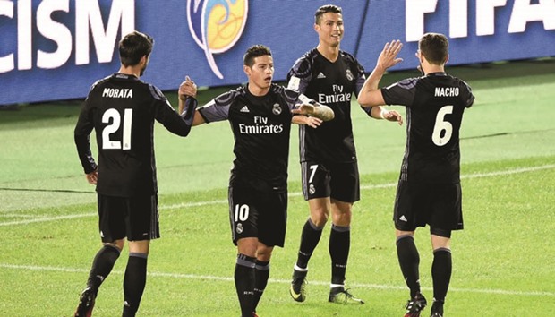 Real Madrid forward Cristiano Ronaldo (second from right) is congratulated by teammates after scoring against Club America in their Club World Cup semi-final clash yesterday. (AFP)