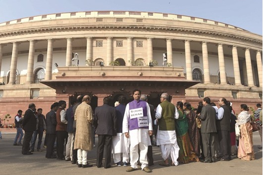 Trinamul Congress party members hold placards during a protest against demonetisation at Parliament House in New Delhi yesterday.