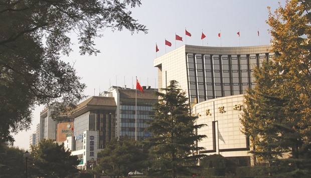The Peopleu2019s Bank of China headquarters (right) is seen in Beijing. The PBoC has maintained a prudent monetary policy since 2011, raising or cutting interest rates in line with shifts in the economy.