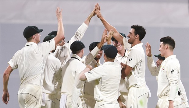 Australiau2019s Mitchell Starc (second from right) celebrates the wicket of Pakistanu2019s Yasir Shah on the second day of the first Test in Brisbane yesterday. (AFP)