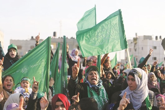 Palestinians take part in a rally marking the 29th anniversary of the founding of the Hamas movement, in Rafah in the southern Gaza Strip yesterday.