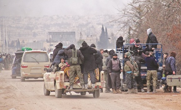 Syrian rebel fighters and civilians who were evacuated from rebel-held neighbourhoods in the embattled city of Aleppo arrive in the opposition-controlled Khan al-Aassal region, west of the embattled city.