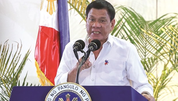 President Rodrigo Duterte gestures during a press conference shortly after arriving from Singapore a