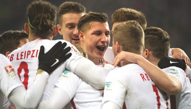 Leipzig captain Willi Orban celebrates with teammates after scoring the second goal for his side in their Bundesliga match against Hertha Berlin in Leipzig yesterday. (AFP)