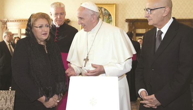 JUST ANOTHER WORK DAY: Pope Francis exchanging gifts with Malta President Coleiro and her husband Edgar during a meeting at the Vatican yesterday.