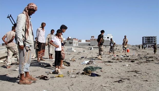 Yemenis gather at al-Sawlaba base in Aden's al-Arish district on Sunday, after a suicide bomber targeted a crowd of soldiers.