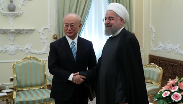 Iranian President Hassan Rouhani greets Yukiya Amano, Director General of the International Atomic Energy Agency, in Tehran on Sunday.