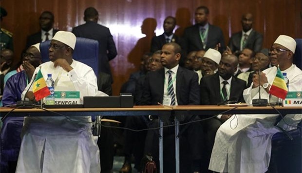 Senegal President Macky Sall (left) sits with the President of Mali Ibrahim Boubacar Keita during the ordinary session of the ECOWAS heads of state and government in Abuja, Nigeria on Saturday.