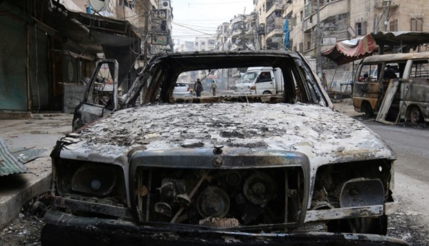 A burnt car is pictured in a rebel-held sector of eastern Aleppo