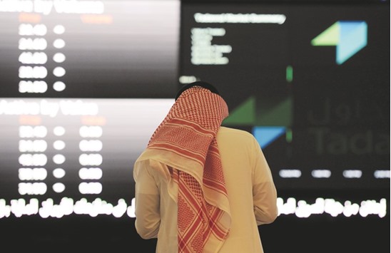 A Saudi investor monitors shares at the Saudi Stock Exchange, or Tadawul (file). Saudi Arabian petrochemical shares were bid up yesterday with all 14 listed producers advancing, pulling the main Saudi stock index 0.7% higher.