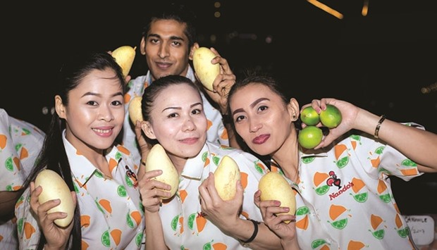 Nandou2019s staff pose with mangoes and lime at the launch of the new flavour.