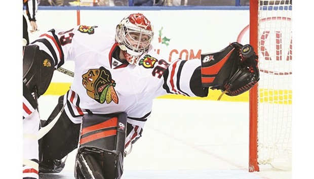 Chicago Blackhawks goaltender Scott Darling reaches for the puck in the third period against the St. Louis Blues at the Scottrade Center in St. Louis. (St. Louis Post-Dispatch/TNS)