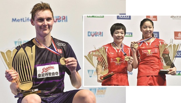 Viktor Axelsen of Denmark poses with his trophy after winning his menu2019s singles final against Tian Houwei of China in the BWF Dubai World Superseries Finalsat the Hamdan Sports Complex in Dubai.  RIGHT: Chen Qingchen and Jia Yifan of China pose with their trophies after winning their womenu2019s doubles final match against Misaki Matsutomo and Ayaka Takahashi of Japan in the BWF Dubai World Superseries Finals at the Hamdan Sports Complex in Dubai. (AFP)