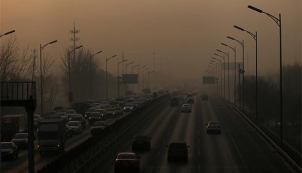 Vehicles drive on the 5th Ring Road in smog during morning rush hour on the fourth day after a red alert was issued in Beijing, on Monday.