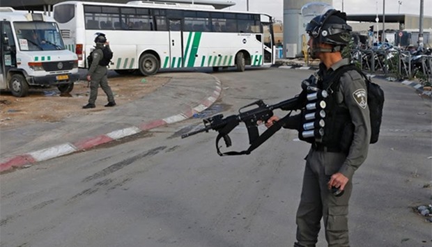A member of the Israeli police stands guard at the checkpoint