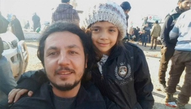 Syrian girl who tweeted from Aleppo, Bana Alabed, posing with IHH aid worker
