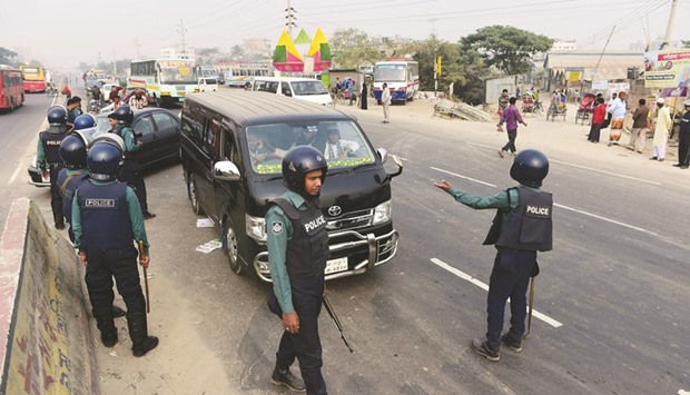Policemen block a vehicle carrying activists of Islamist political party Islami Andolan Bangladesh (IAB) on a road in Dhaka yesterday, as they try to organise a long march towards the border with Myanmar.