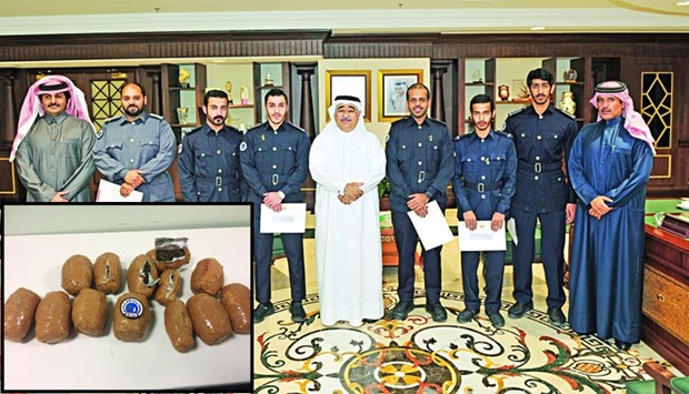 The customs officials who were honoured are seen with GAC chairman Ahmad bin Ali al-Muhannadi and other officials. Inset: Some of the seized packets of marijuana