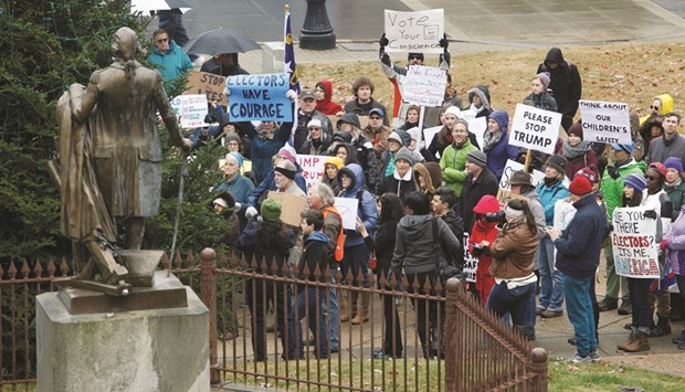 Opponents of US president-elect Donald Trump demonstrate outside the North Carolina State Capitol building before the stateu2019s electors meet to cast their electoral college presidential ballots in Raleigh, North Carolina, yesterday.