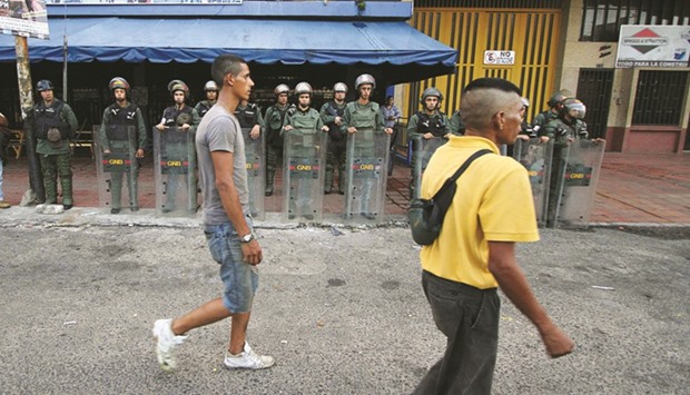Venezuelau2019s National Guard soldiers in riot gear keep watch on the streets of La Fria, Tachira state, Venezuela.