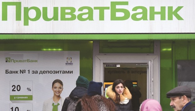 Customers entering a PrivatBank branch in Kiev. Risky lending practices had left a capital shortfall of around $5.65bn on PrivatBanku2019s balance sheet as of December 1, while 97 % of its corporate loans had gone to companies linked to its shareholders, the bank said in a statement.