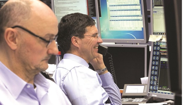 Traders monitor data at the Frankfurt Stock Exchange. The DAX 30 closed up 0.2% to 11,426.70 points yesterday.